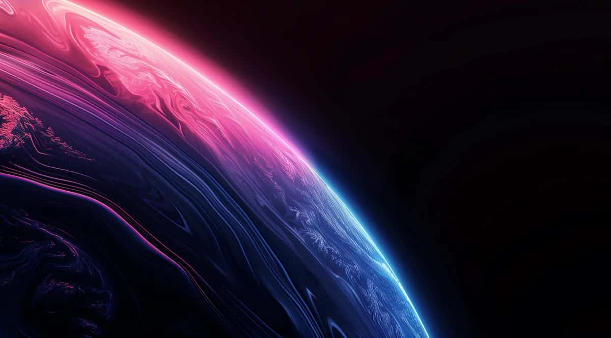 Curved edge of a planet glowing hot pink above marbled indigo against black space
