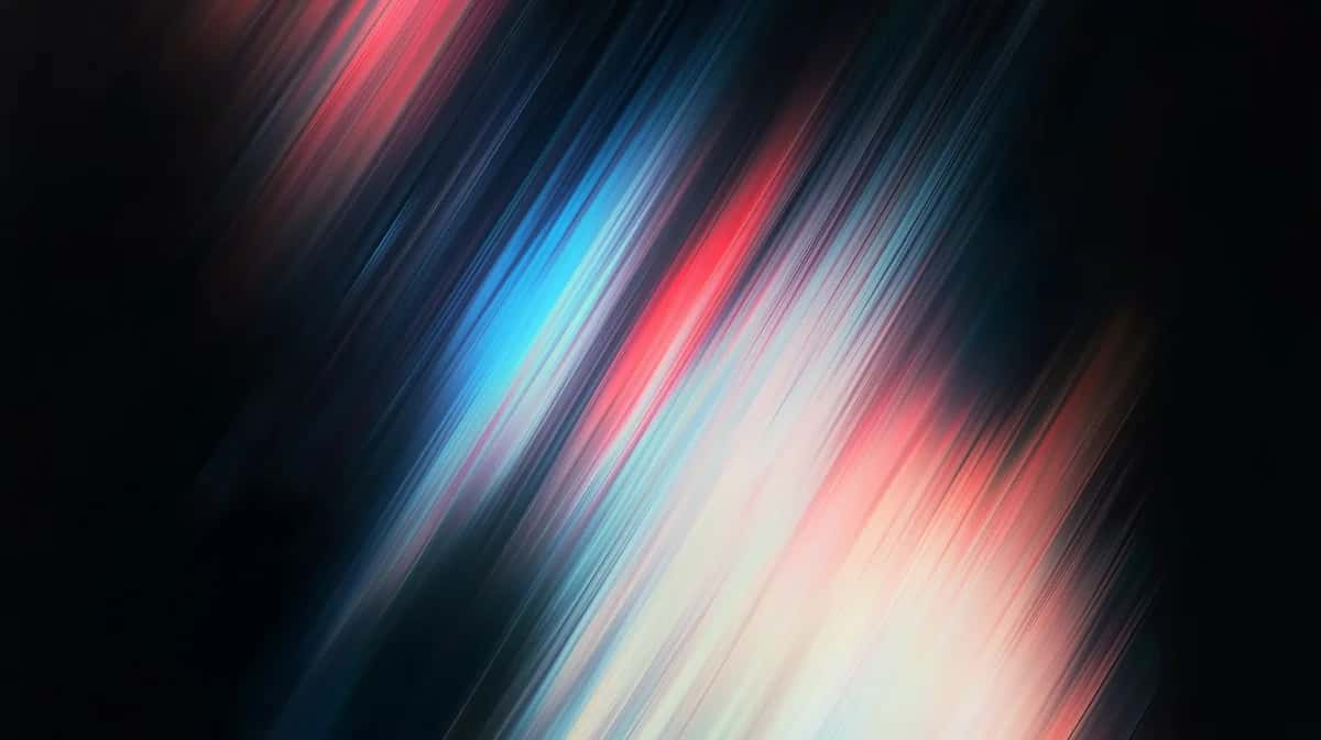 Abstract motion blur with diagonal streaks of blue, pink, and white on dark background