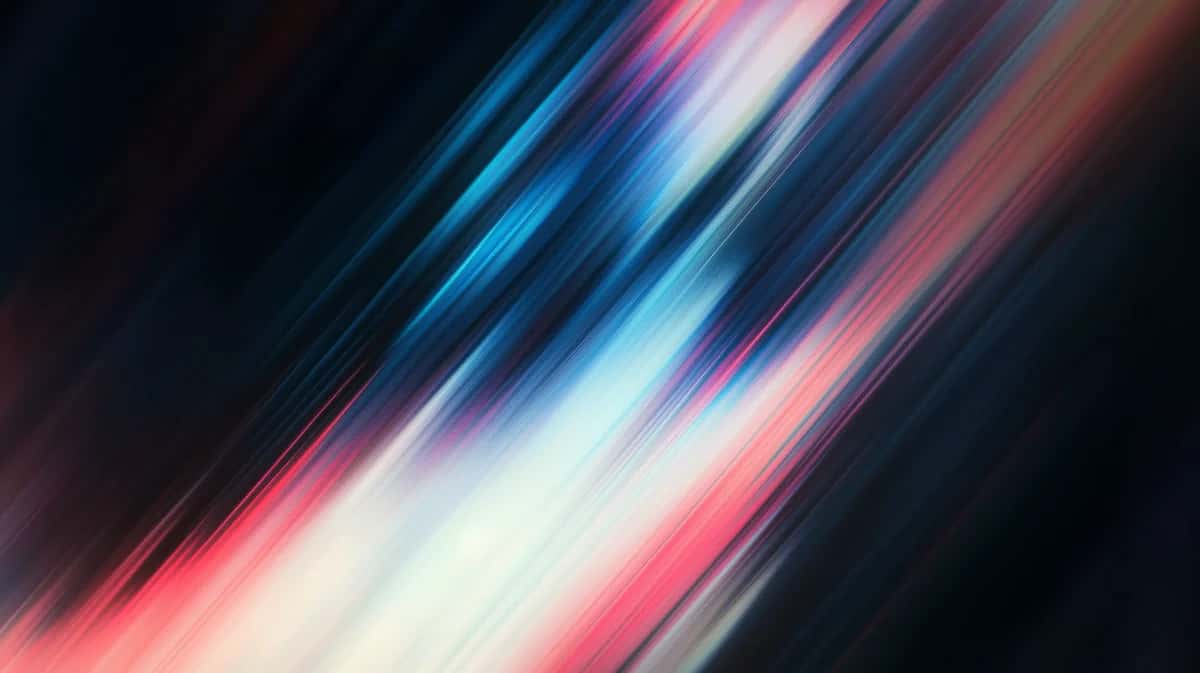 Diagonal motion blur gradient with blue, pink, and white streaks on dark background