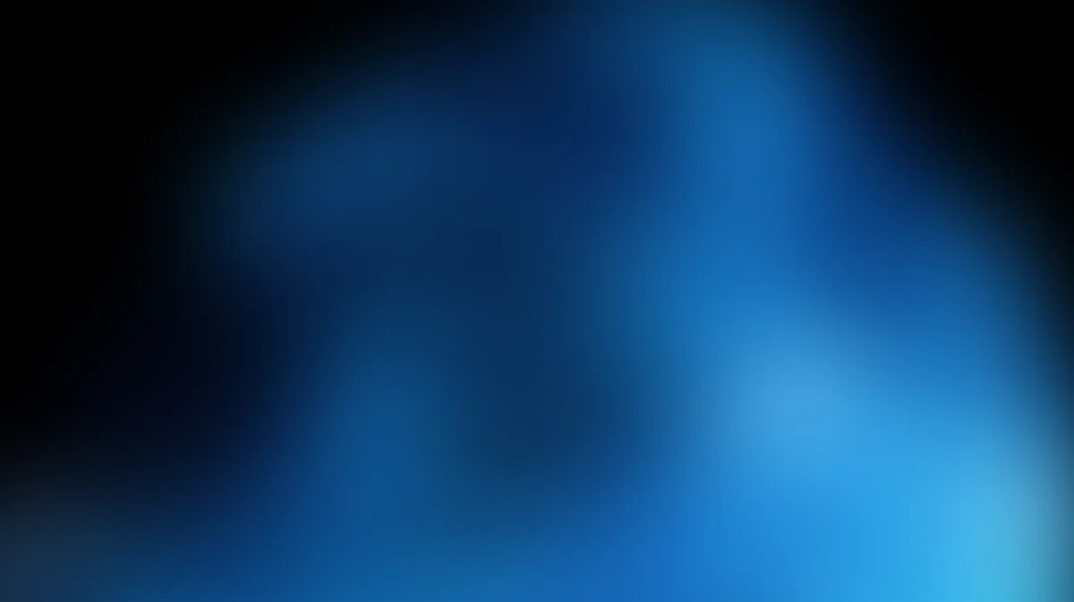 Abstract blue gradient background with soft light effects and dark edges, blurred bokeh