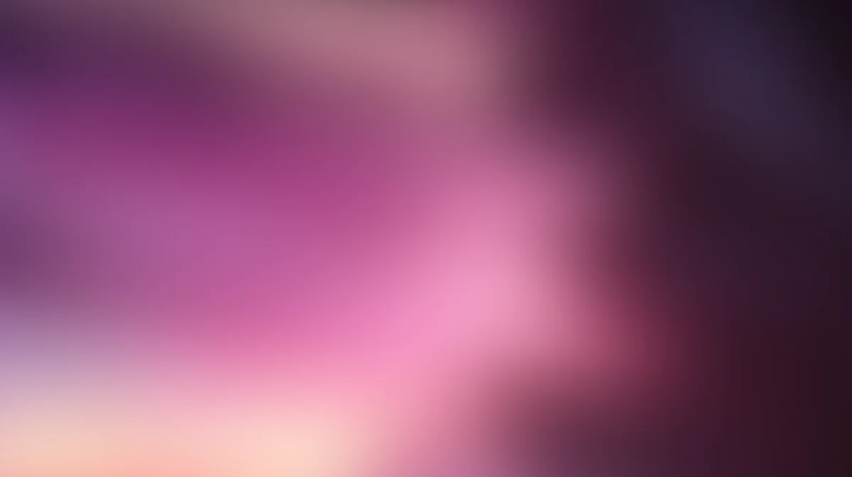 Abstract blurred gradient background with pink, purple, and dark tones blending smoothly