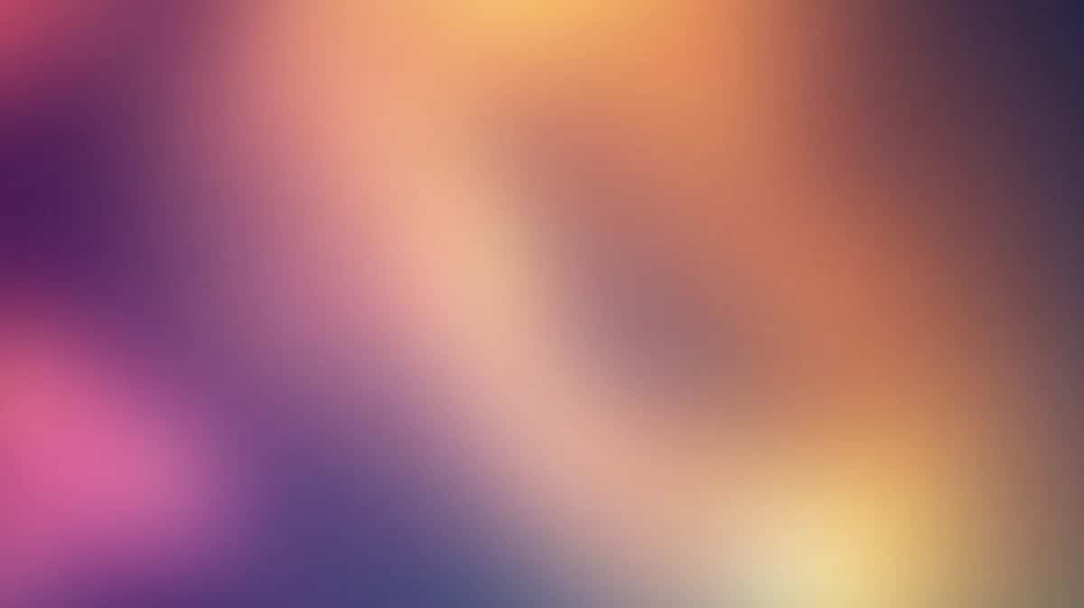 Soft blurred gradient background with pink, purple, orange, and yellow hues blending seamlessly