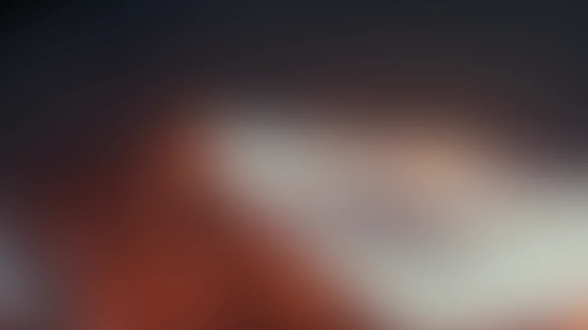 Abstract gradient background with warm orange red transitioning to soft white and cream tones