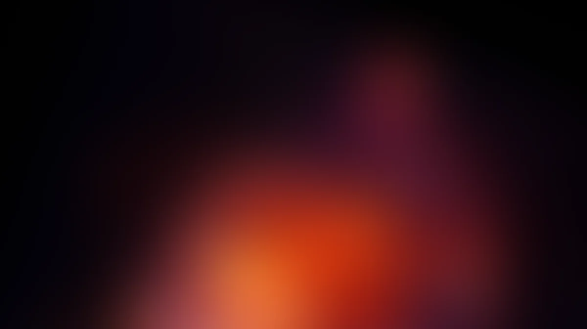 Abstract gradient background transitioning from orange and red to dark purple and black