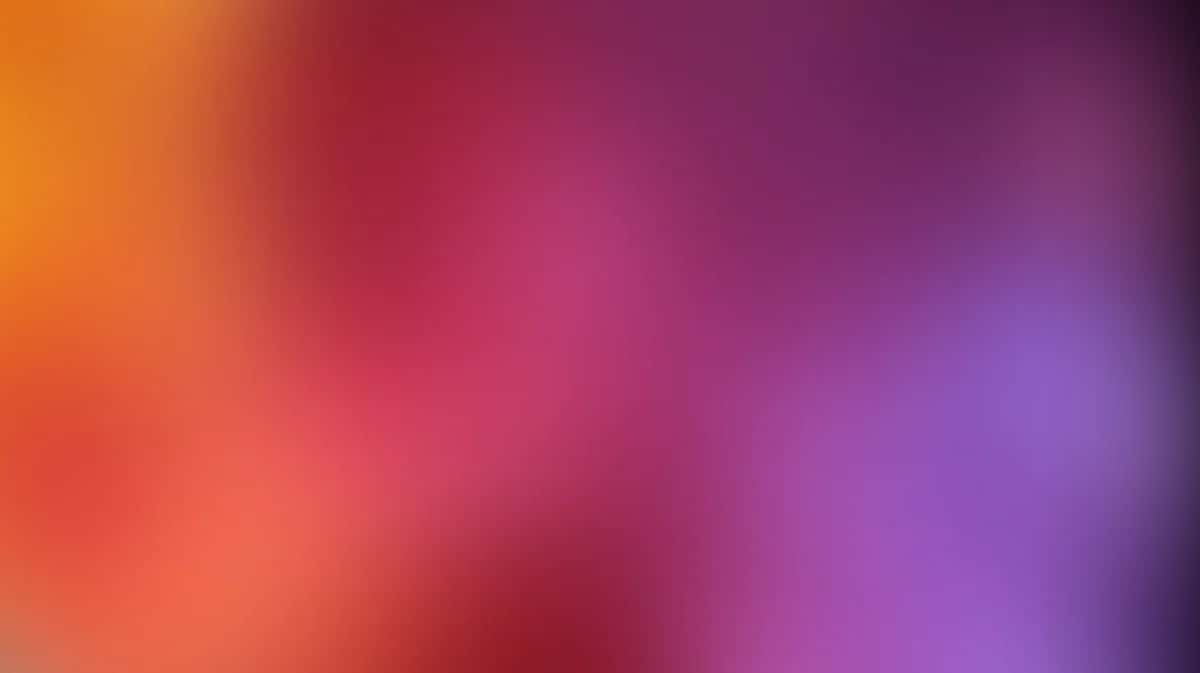 Smooth gradient background transitioning from warm orange to pink to purple