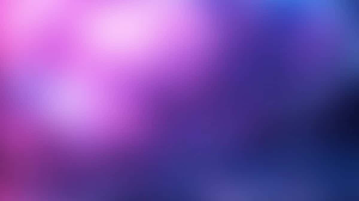 Soft gradient background transitioning pink purple blue with blurred bokeh light effects