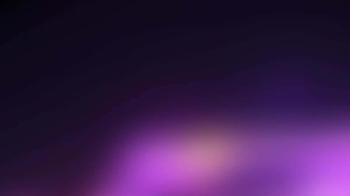 Abstract gradient background with soft purple and magenta glow on dark navy base