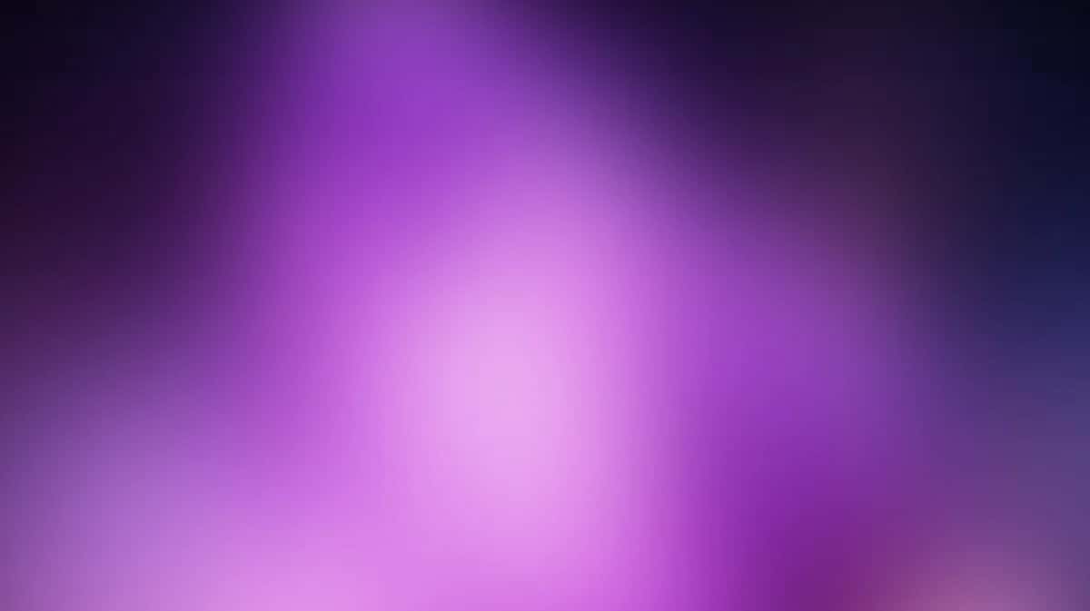 Blurred purple and magenta gradient background with soft radial light effect