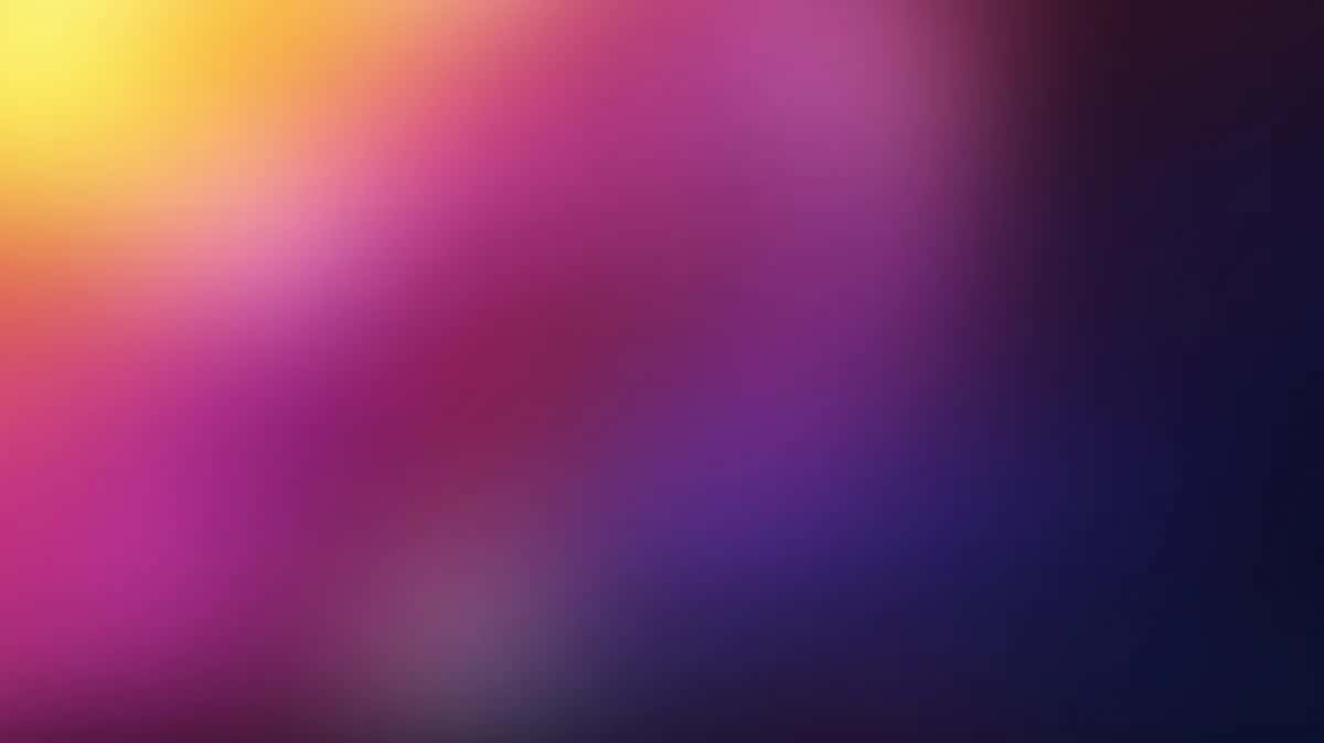 Vibrant gradient wallpaper transitioning from yellow and pink to purple and dark blue