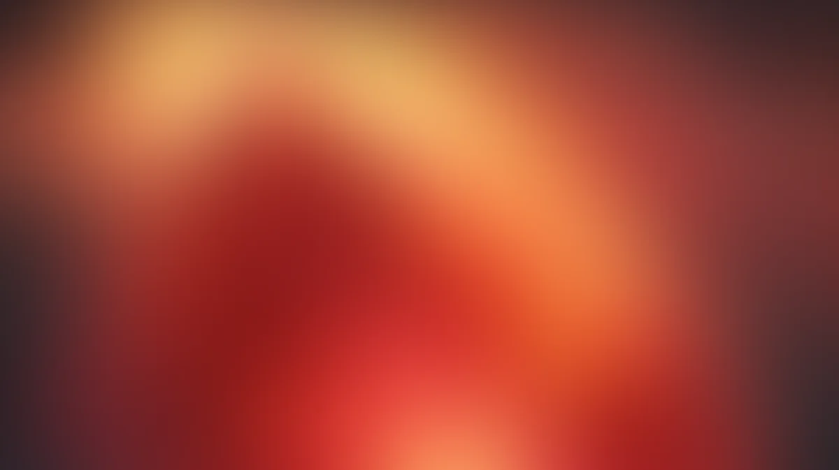 Abstract gradient wallpaper with warm orange, red, and amber tones blending softly
