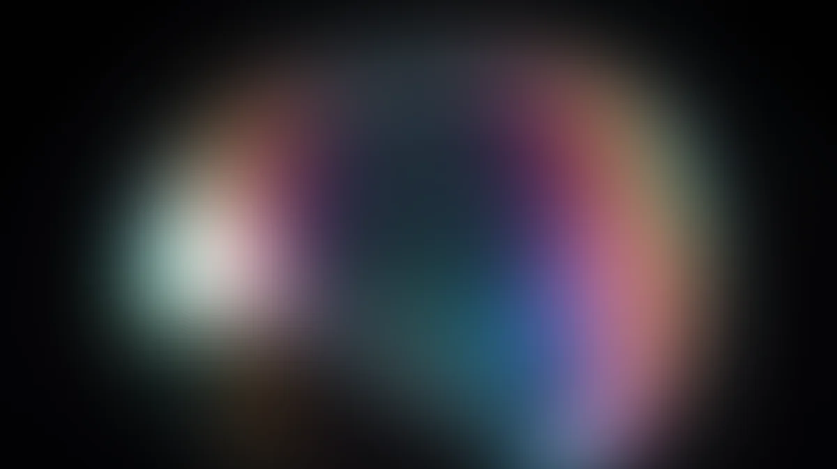 Abstract blurred gradient with pink, blue, and white light radiating from center on dark background