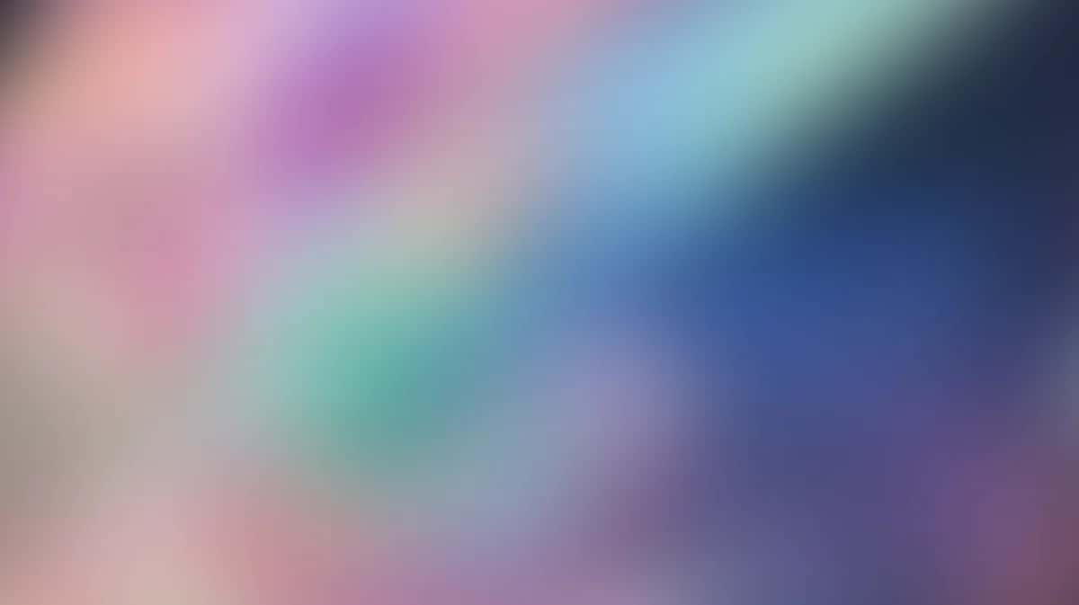 Soft blurred gradient background with pink, purple, blue, and teal flowing colors