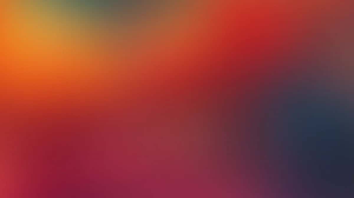 Vibrant gradient background transitioning from orange and red to deep blue and purple tones