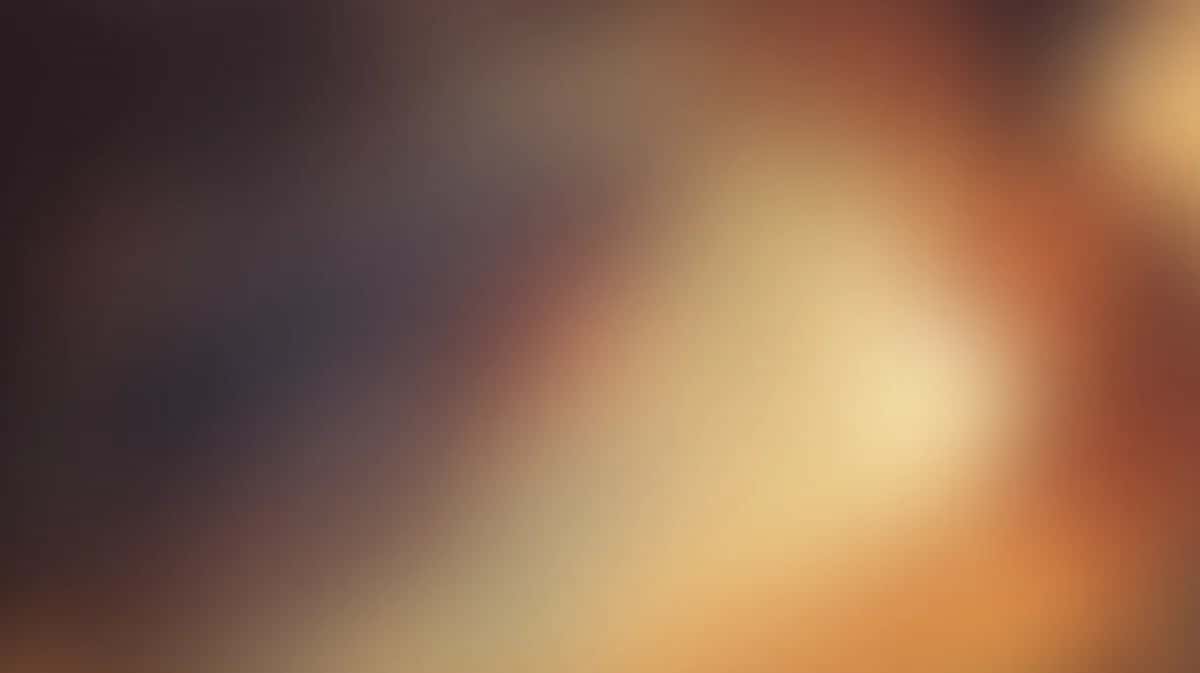 Abstract warm gradient background blending cream, orange, and brown tones with soft blur