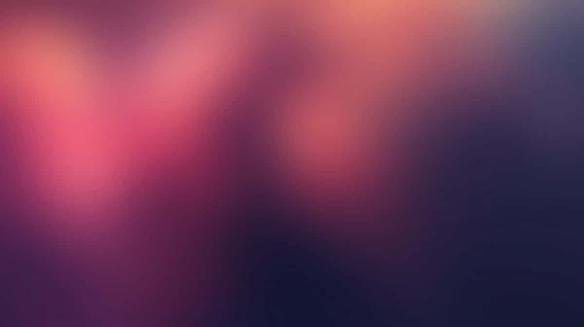 Soft blurred gradient background transitioning from pink and coral to deep purple and navy blue