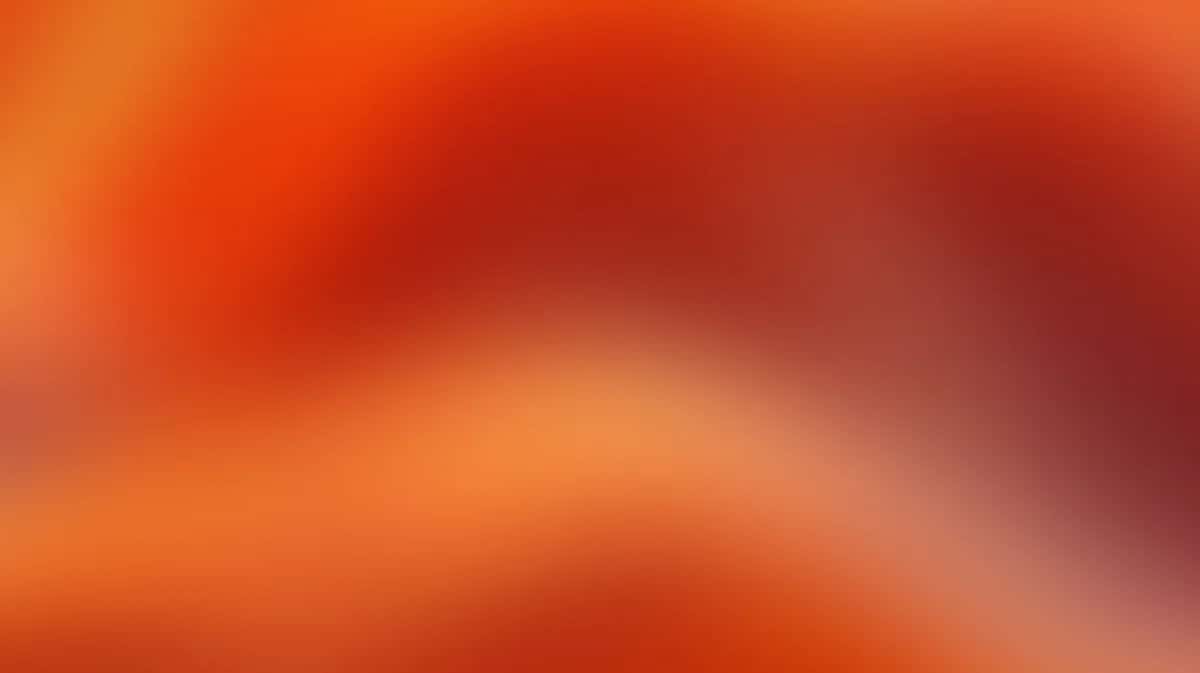 Warm orange gradient background with soft blurred transition from deep red to peachy tones