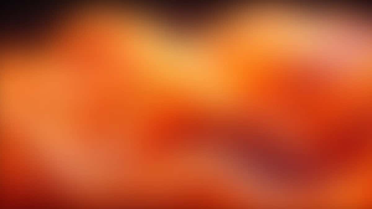 Warm gradient background blending orange, red, and yellow tones with soft blur effect