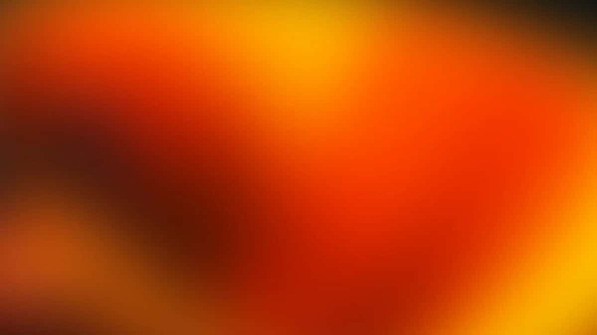Abstract gradient background with warm orange, red, and yellow tones blending smoothly