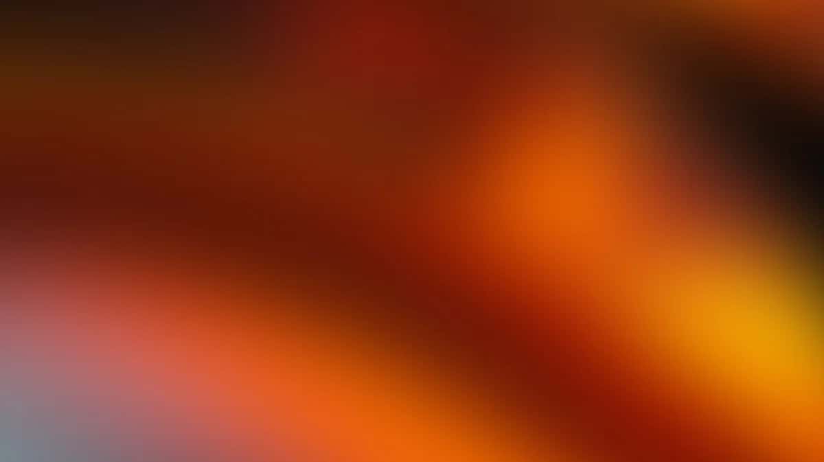 Abstract warm gradient background blending red, orange, and yellow tones
