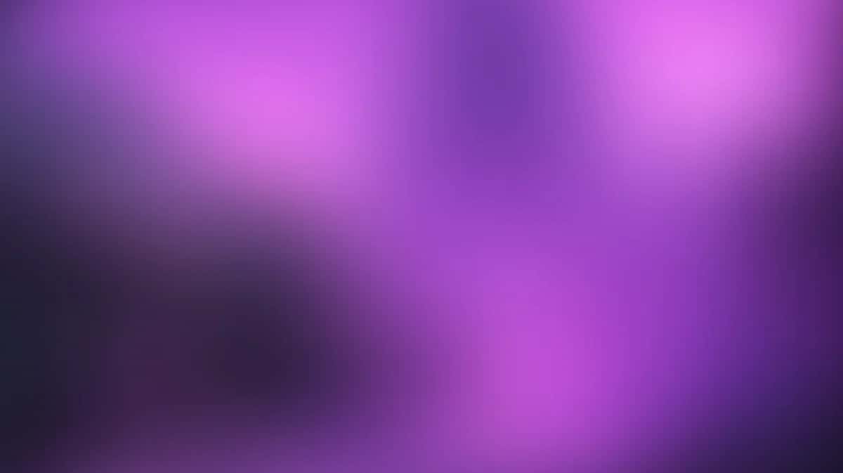 Abstract purple gradient background with soft blurred light effects and dark vignetting