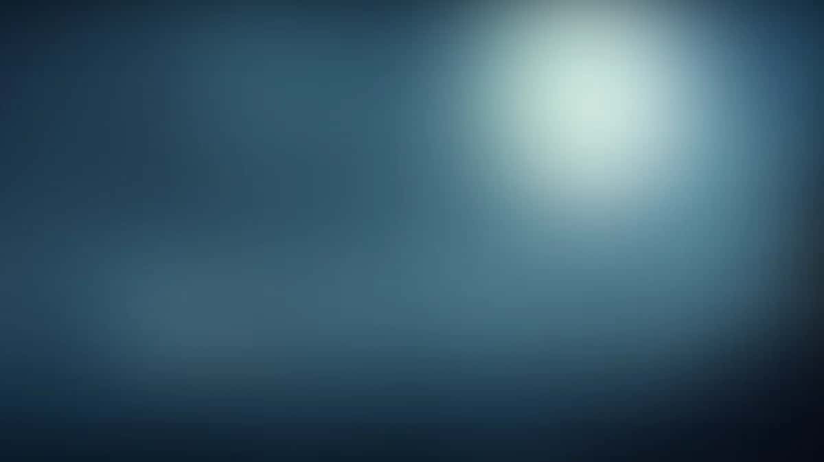 Soft blue gradient background with bright light source and blurred bokeh effect