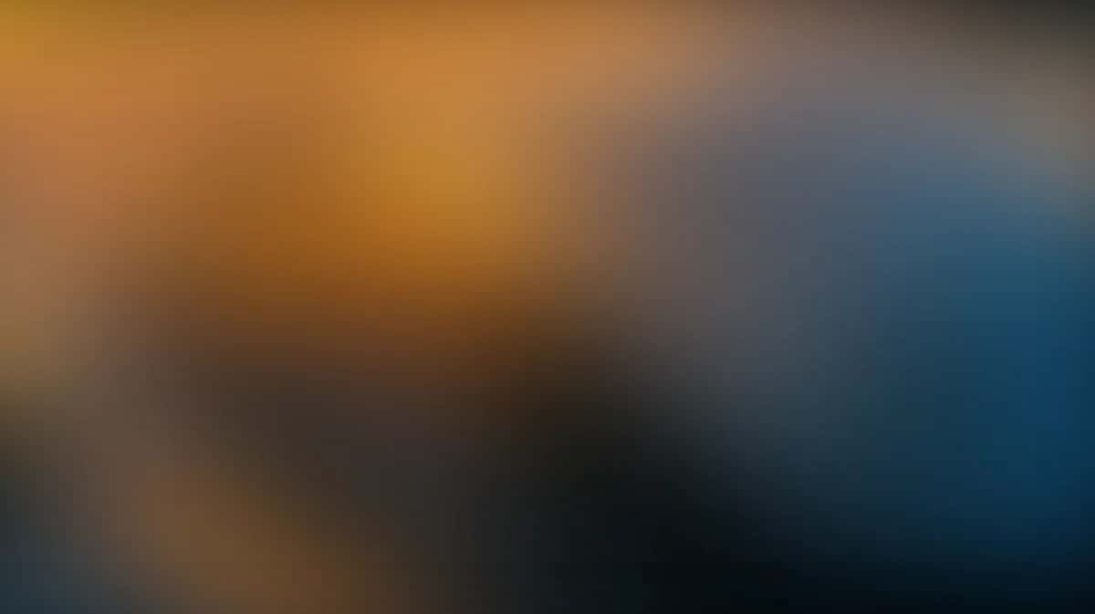 Soft gradient background transitioning from warm orange and gold to cool blue and teal tones