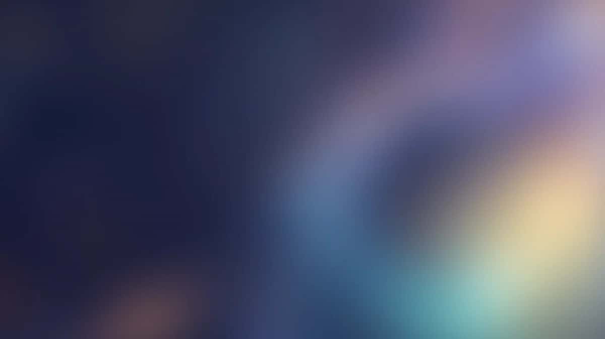 Soft blurred gradient background with blue, purple, and warm yellow tones blending together