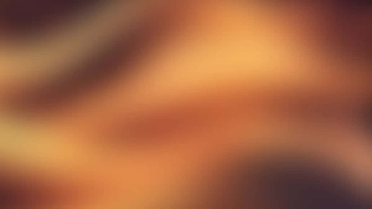Abstract warm gradient background with orange, amber, and brown tones blending smoothly