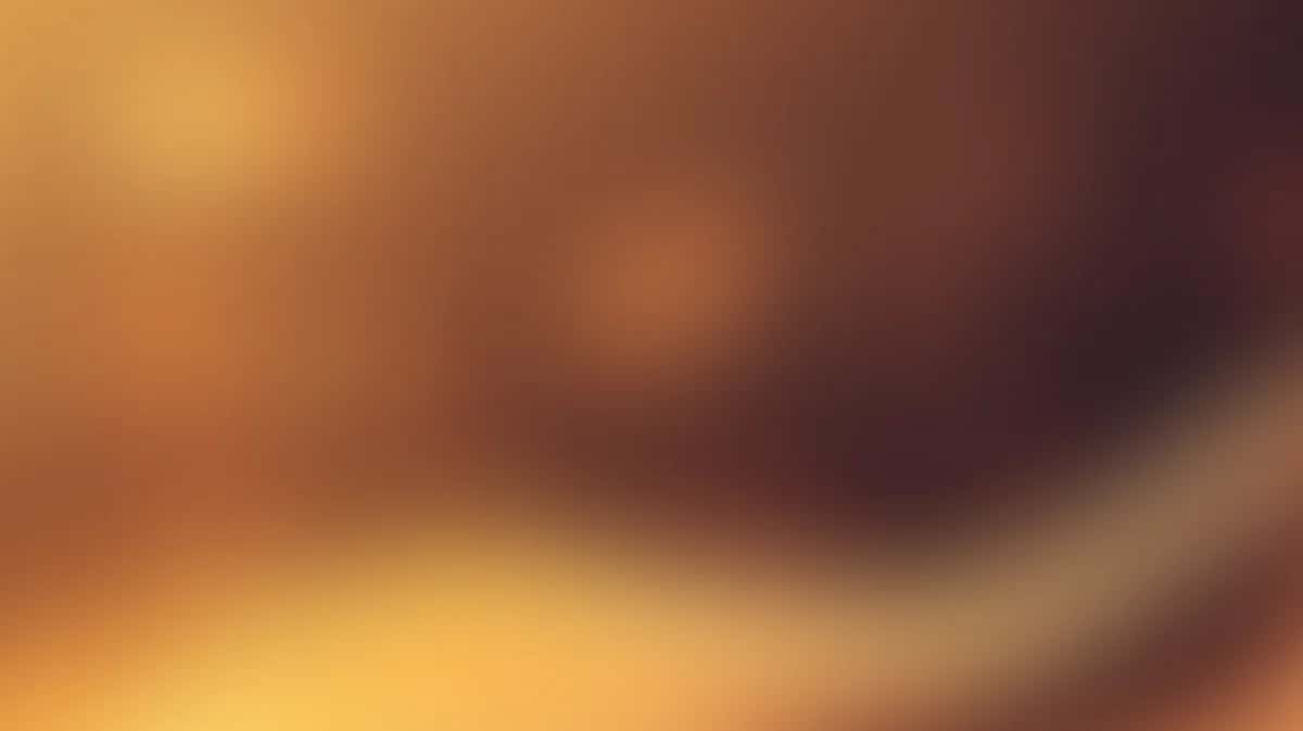 Abstract warm gradient background with orange, gold, and brown tones, soft blurred bokeh effect