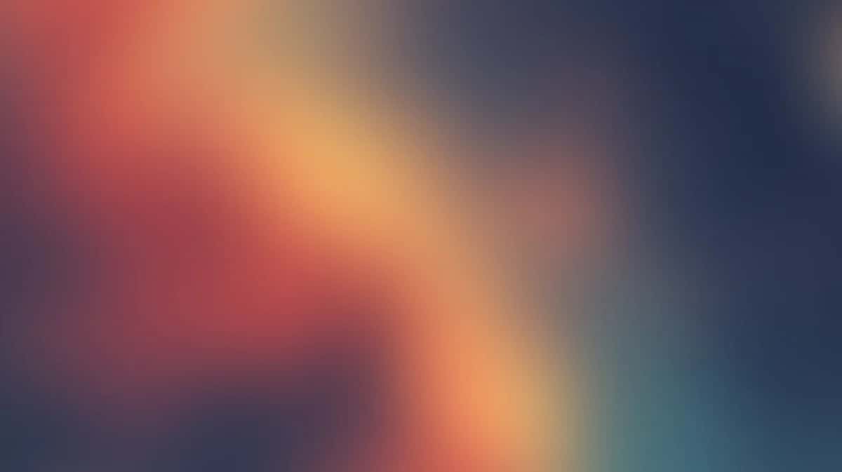 Abstract gradient background with warm orange and cool teal colors blending softly