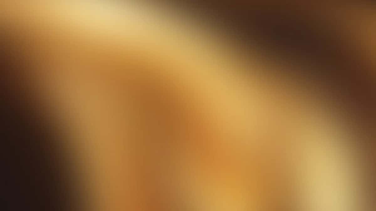 Soft warm gradient background transitioning from golden yellow to deep brown with blurred diagonal light rays