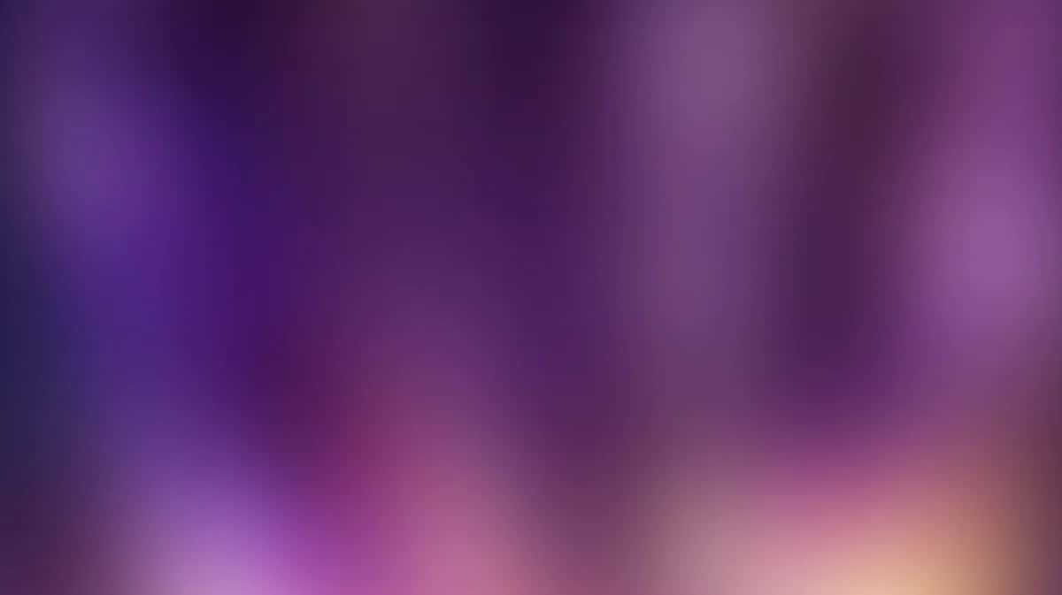 Soft blurred gradient background transitioning purple pink to warm peachy tones