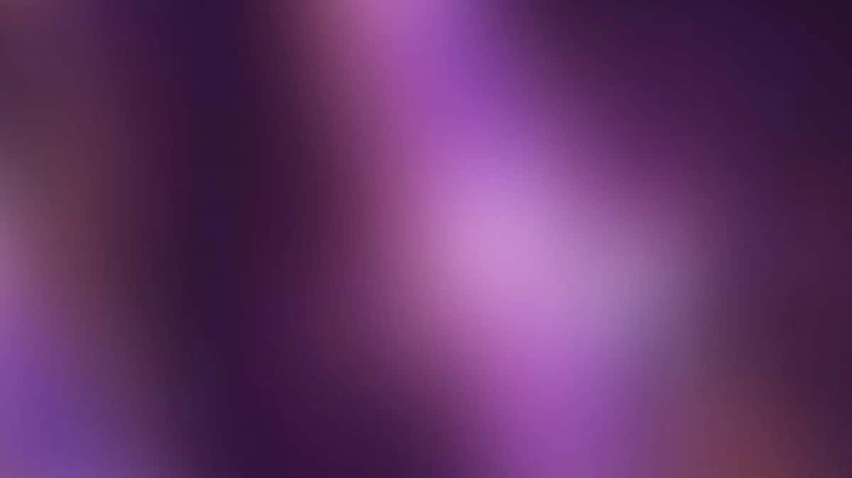 Soft blurred gradient background transitioning from deep purple to pink with radiant light center