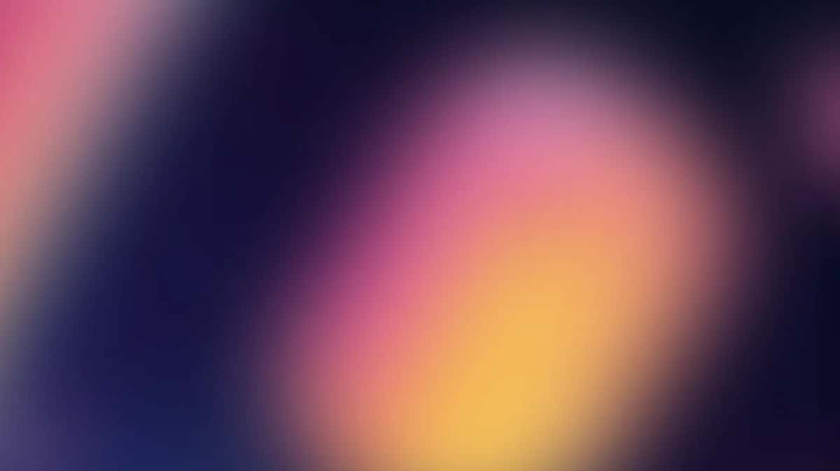 Soft blurred gradient wallpaper with pink, yellow, and navy blue colors