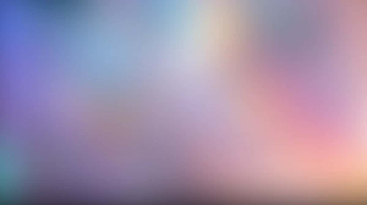 Soft gradient wallpaper blending purple, pink, blue and peach tones with blurred bokeh effect