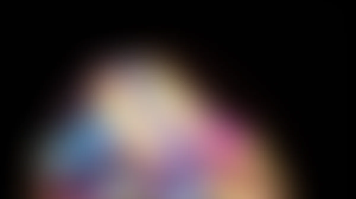 Soft blurred gradient background with blue, pink, purple, and cream tones radiating from center