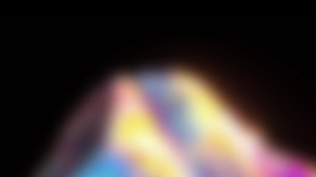 Abstract blurred gradient background with soft pink, blue, yellow, and purple light rays
