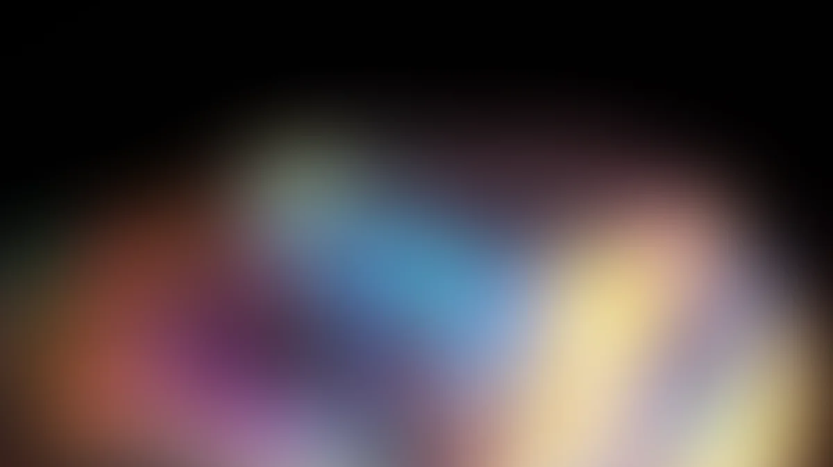 Abstract blurred gradient background with warm orange, cool blue, and soft yellow tones blending together
