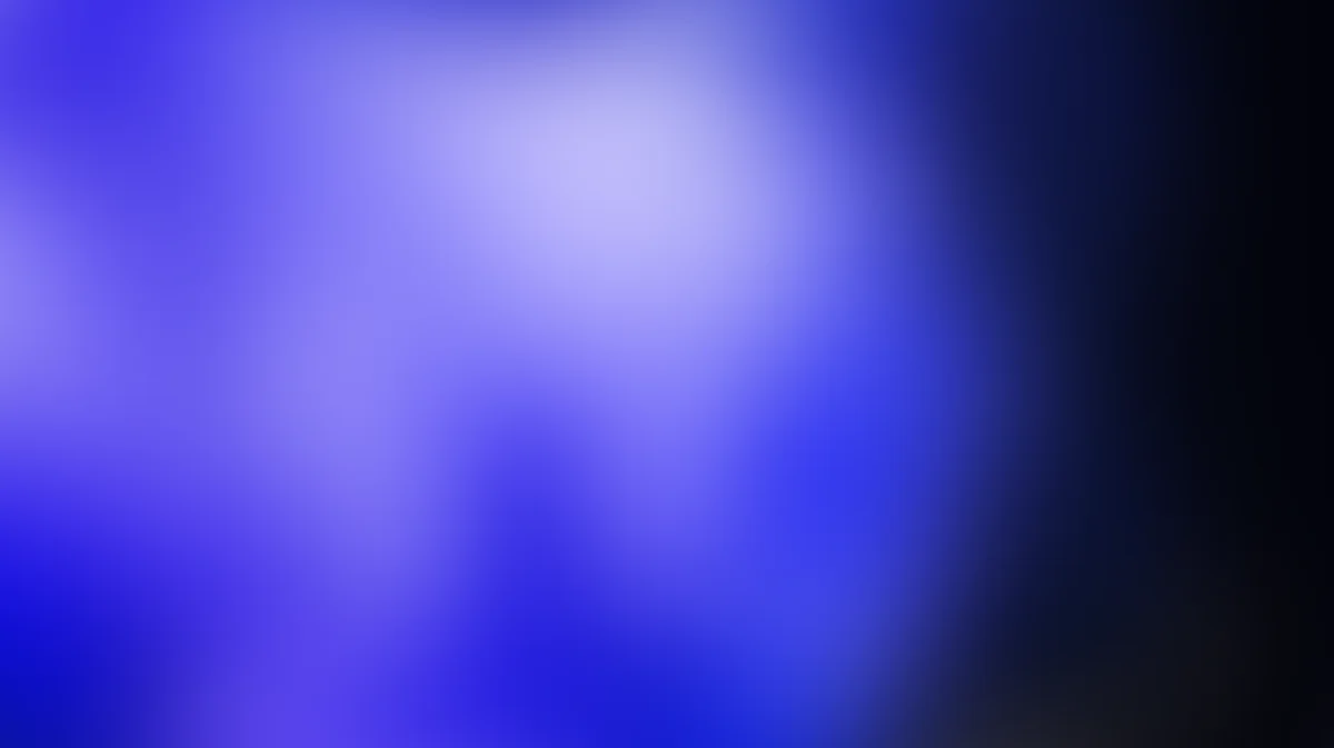 Abstract blue gradient background with soft light center and dark edges, blurred bokeh effect