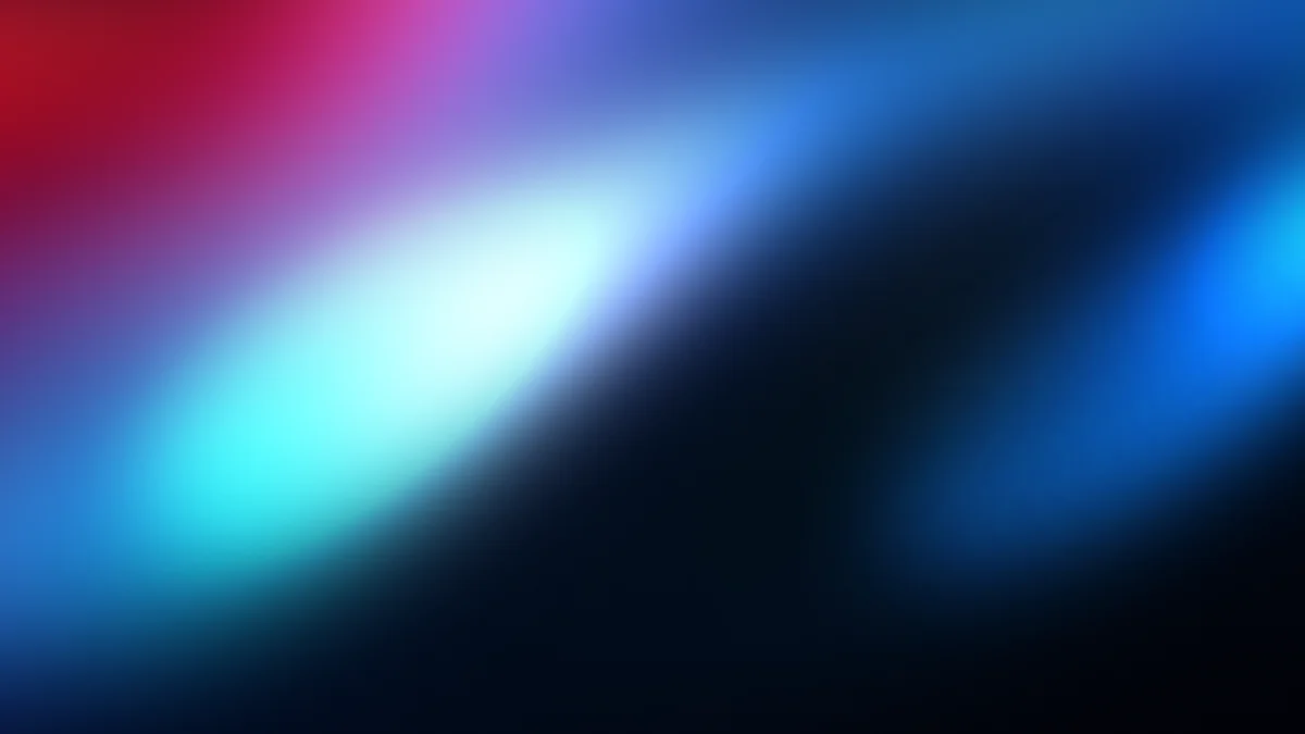 Abstract gradient blur with cyan, blue, and red light streaks on dark background