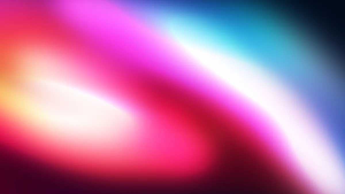 Vibrant gradient blur with pink, magenta, cyan, and white flowing diagonally across dark background