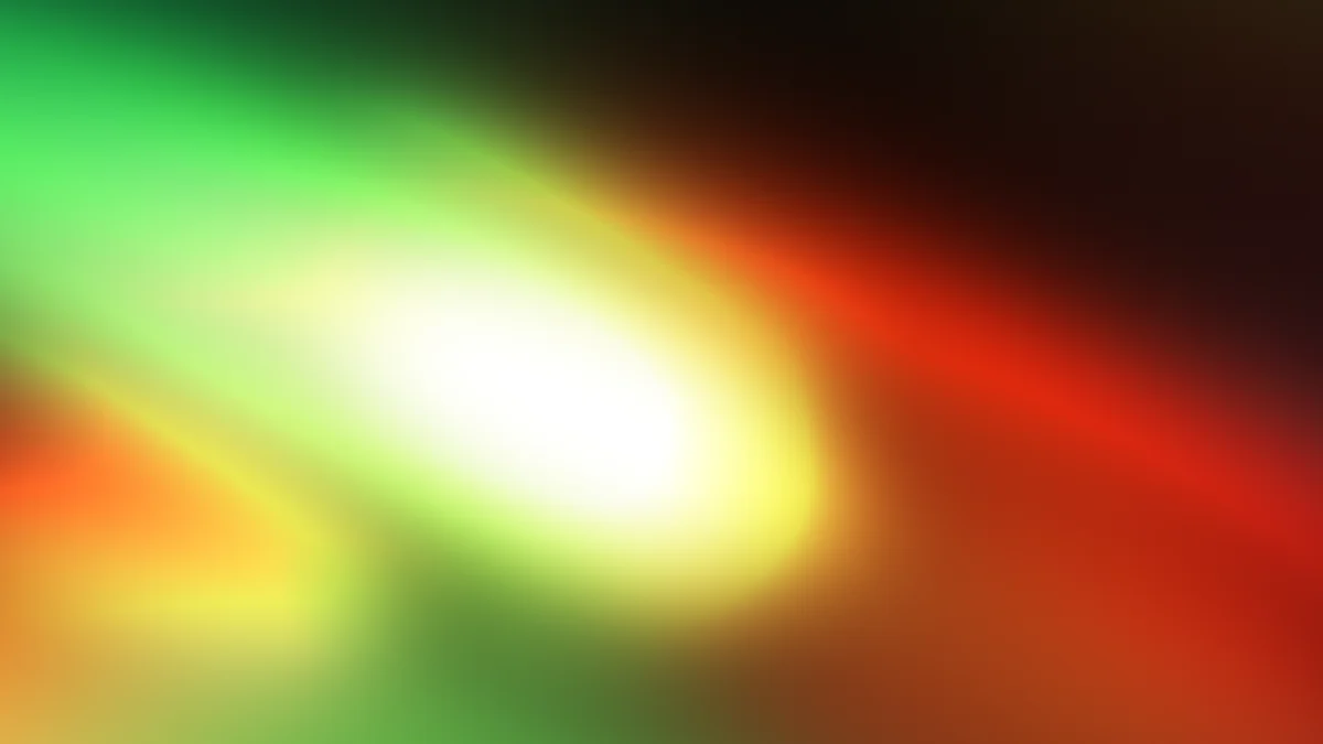 Vibrant gradient blur with green, yellow, orange, and red tones radiating from bright center