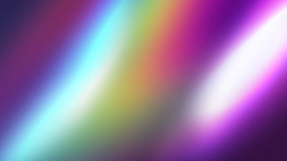 Blurred rainbow gradient transitioning from cyan through yellow to magenta and white on dark purple background