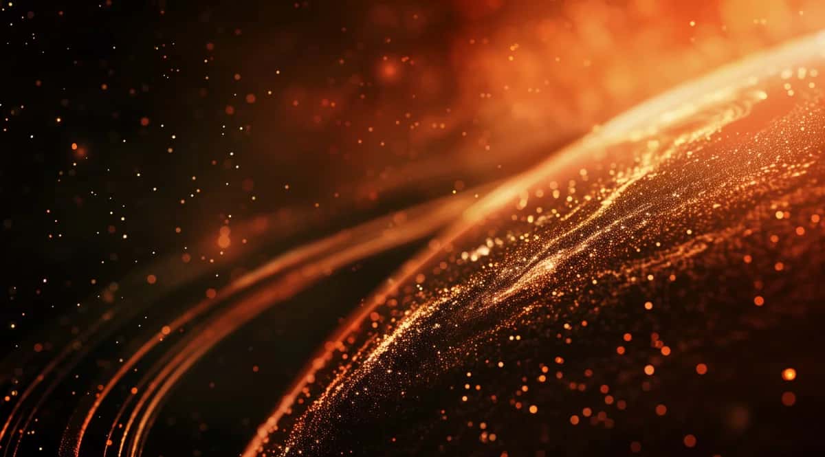 Abstract golden orange particles flowing across dark background, warm glowing light effect