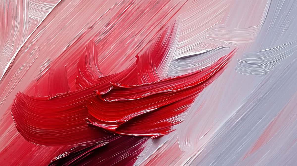 Abstract red and pink brushstrokes with flowing motion on soft white and gray background