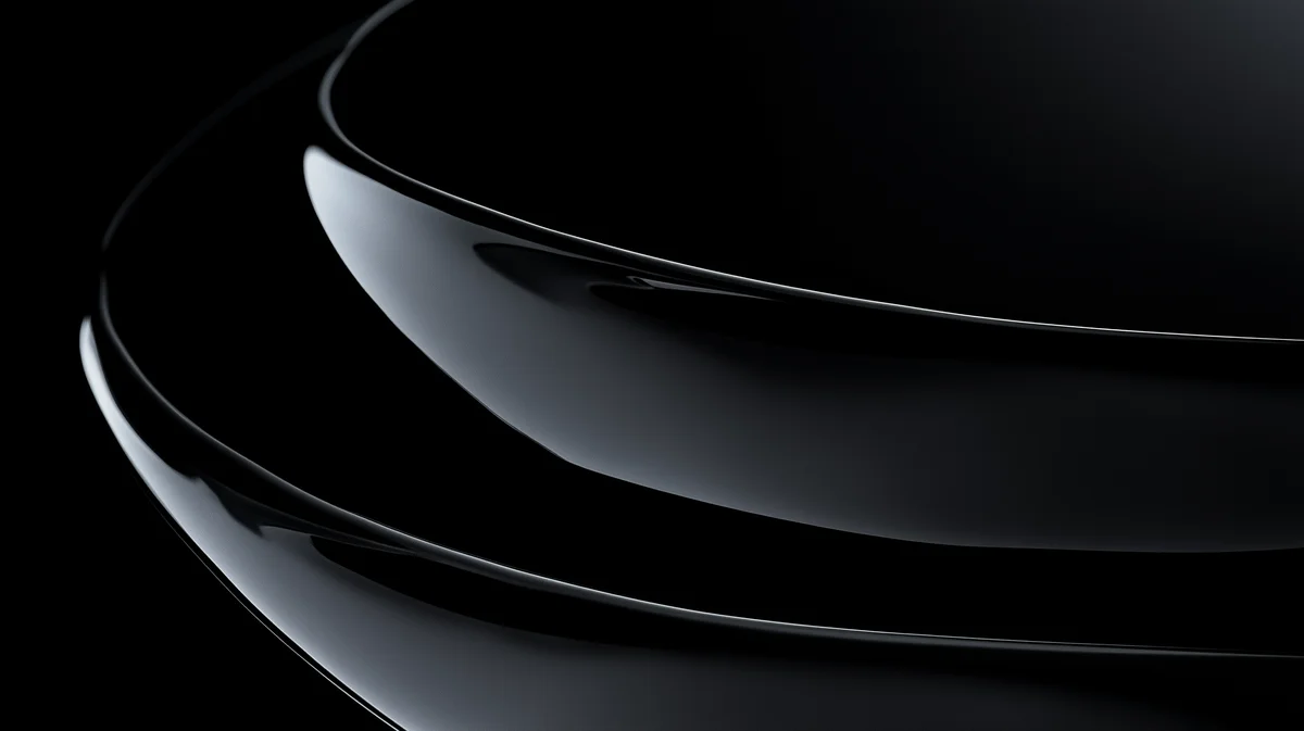 Nested glossy black curved forms with subtle grey reflections in darkness