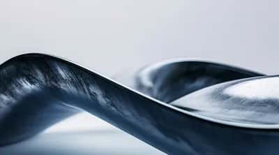 Glossy twisted steel-blue 3D ribbon curving across a pale grey backdrop