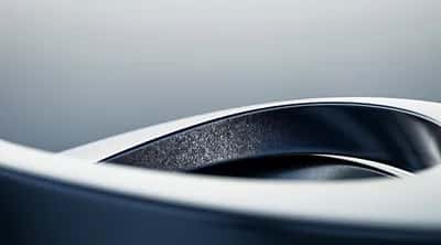 Sleek white-edged 3D curve revealing a dark speckled navy interior
