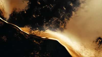 Glowing gold flow winding through dark smoky earth-toned cloud textures