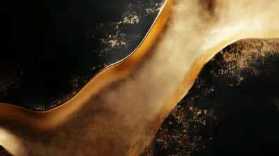 Molten gold ribbon curving across deep black with scattered gold dust